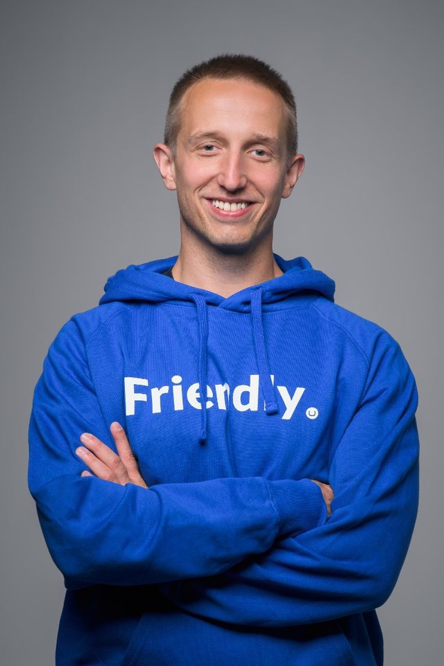 Marcin Zajkowski, author of Prompting for Babies, smiling with arms crossed in a blue hoodie